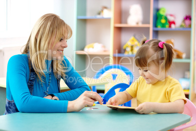 Teacher with child in preschool