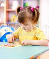 Little girl coloring a picture in preschool