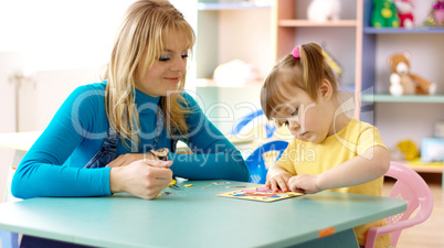 Teacher with child in preschool