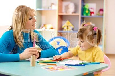 Teacher with child in preschool