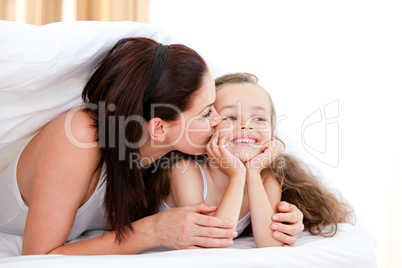 Attentive mother kissing her daughter