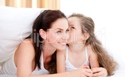 Adorable little girl kissing her mother