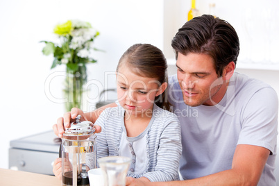 Attentive father and his daughter having breakfast together