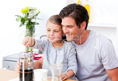 Happy father and his daughter having breakfast together