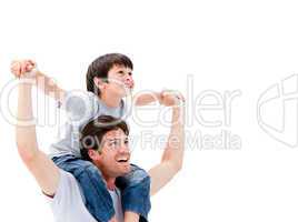 Joyful father giving piggyback ride to his son