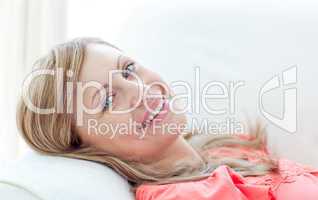 Portrait of a smiling woman lying on a sofa