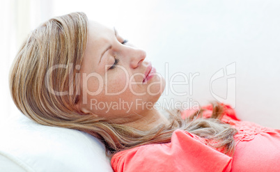 Portrait of an attractive woman sleeping lying on a sofa