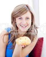 Joyful woman holding a danish pastry
