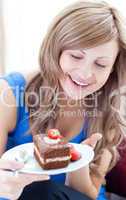 Happy woman holding a piece of chocolate cake