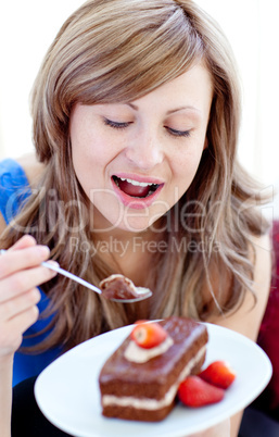 Young woman holding a piece of chocolate cake