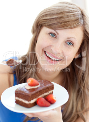 Bright woman holding a piece of chocolate cake