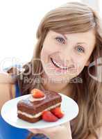 Bright woman holding a piece of chocolate cake