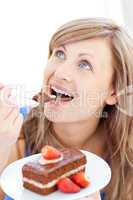 Delighted woman holding a piece of chocolate cake