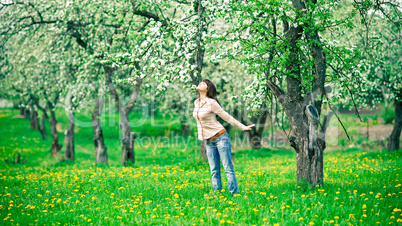 Woman smelling apple flowers