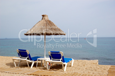 Beach and sunbeds of popular hotel, Crete, Greece