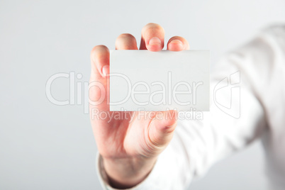 Business card blank in a hand on the white