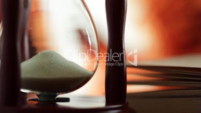 hourglass and book