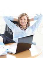 Smiling businesswoman looking at the laptop