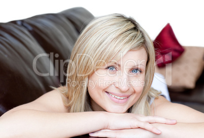 Portrait of a cheerful woman lying on the sofa