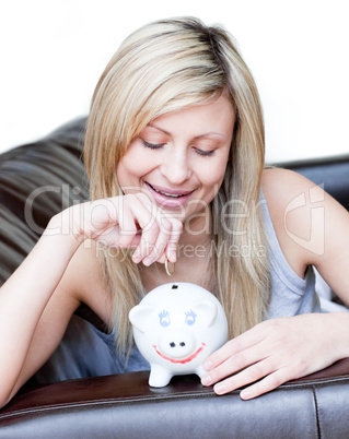 Radiant woman using a piggybank