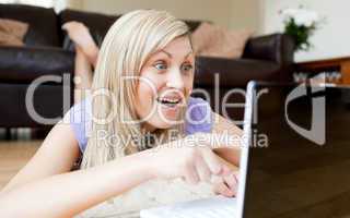 Astonished woman using a laptop