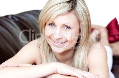Portrait of a smiling woman lying on the sofa