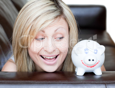 Happy woman using a piggybank
