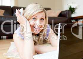 Joyful woman using a laptop