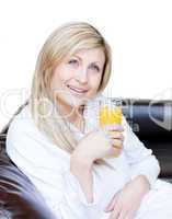 Radiant woman drinking an orange jus