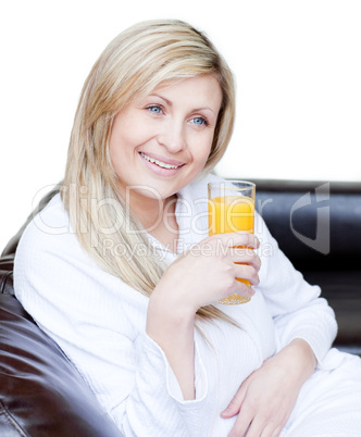 Smiling woman drinking an orange jus