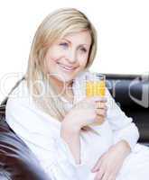 Smiling woman drinking an orange jus