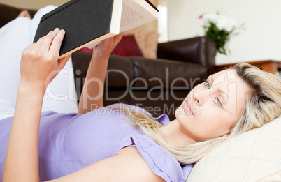 Delighted woman reading a book