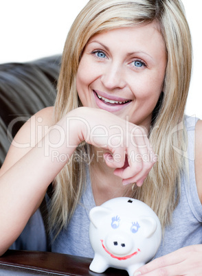 Beautiful woman using a piggybank