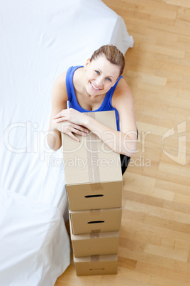 Attractive woman is moving various boxes