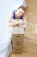 Bright woman is moving various boxes