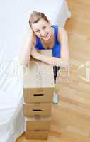Smiling woman is moving various boxes