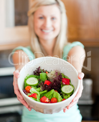Happy woman showing a salad