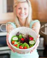 Happy woman showing a salad