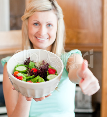 Positive woman showing a salad