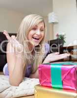 Astonished woman looking at a present