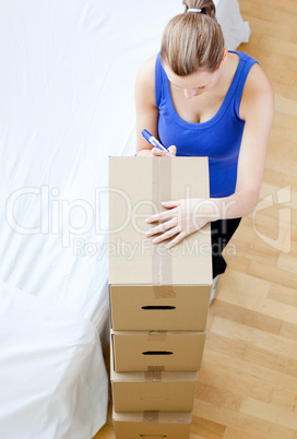 Caucasian woman is moving various boxes