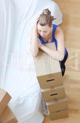 Tired woman is moving various boxes