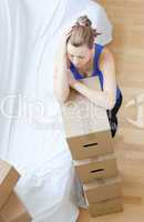 Tired woman is moving various boxes