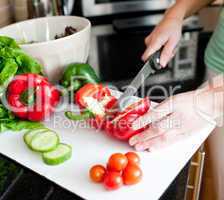 Close-up of a beautiful woman preparing a salad