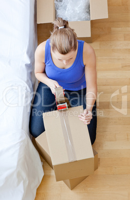 Beautiful woman closing a box