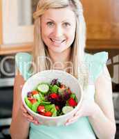Caucasian woman showing a salad
