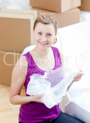 Cheerful woman unpacking box