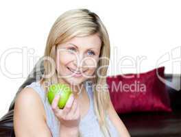 Happy woman eating an apple