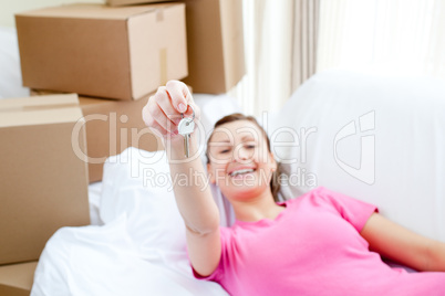 Portrait of a beautiful woman relaxing on a sofa with boxes