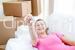 Portrait of a beautiful woman relaxing on a sofa with boxes